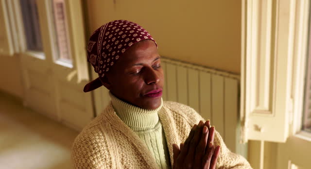 Spiritual Reflection: Woman with Cancer Prays in Quiet Room.
