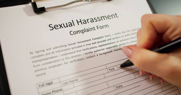 istock Human Hand Filling Sexual Harassment Complaint Form 2033299669