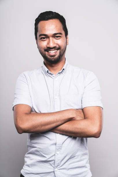 istock Confident Smiling Asian Man Arms Crossed Studio Portrait 2033317647