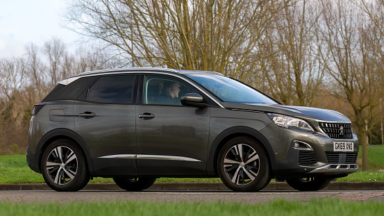 Milton Keynes,UK-Feb 23rd 2024: 2019 grey Peugeot 3008 car driving on an English road