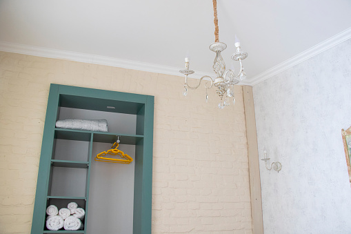 A compact bathroom featuring a wall-mounted light fixture
