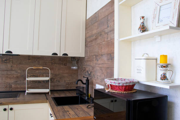 a white sink with wood counter top and cabinets in a kitchen - domestic kitchen kitchen sink contemporary counter top imagens e fotografias de stock