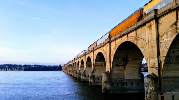 istock Train cars on a bridge over a river 2033352352