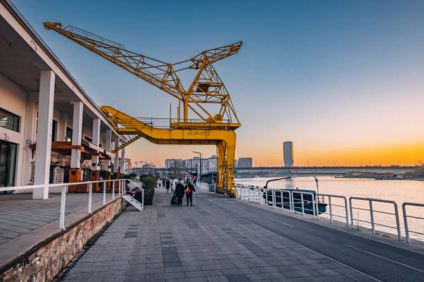 29 November 2023, Belgrade, Serbia: Explore Belgrade's dynamic waterfront promenade, where cranes symbolize industrial past of the city