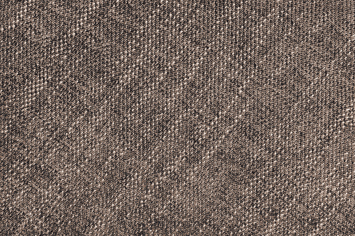 Coarse weave jacquard fabric texture background, brown cloth texture. Textile background, furniture textile material, wallpaper, backdrop. Textile structure close up.