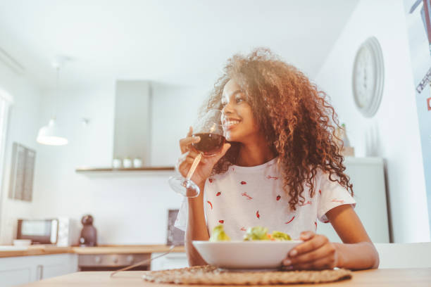 istock Woman at home drinking wine and with salad 2033405047