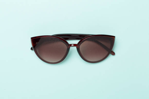 istock Sunglasses on color background, top view. 2033422775