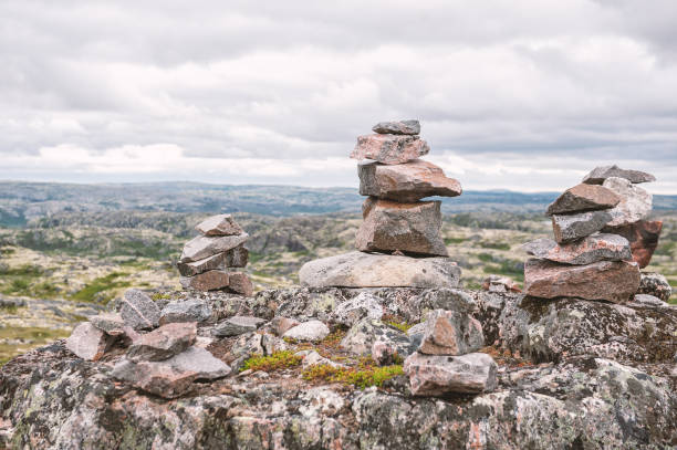 Different stones stacked in a balanced formation on the tundra background