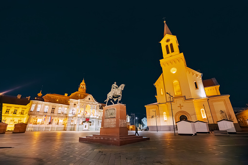 28 January 2024, Zrenjanin, Serbia: Town hall and other landmarks on the main square of the city at night time
