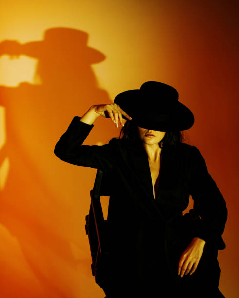 Brunette woman in black suit.