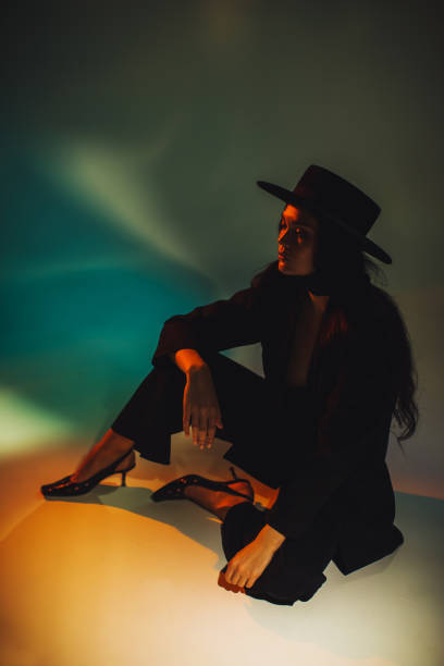 Brunette woman in black suit.