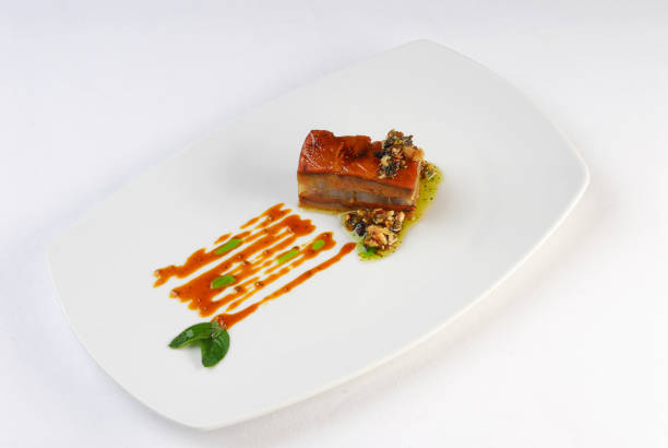 Elegant vegetarian dinner with smoked tofu, potatoes, pumpkin sauce, onion and seaweed