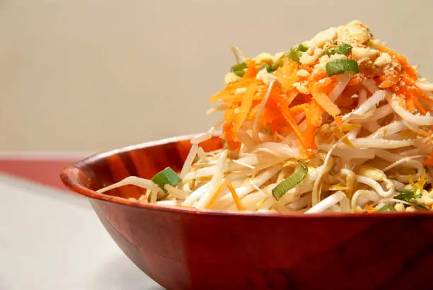 Photo of asian food, bowl of wheat germ with carrot and chives, thai food