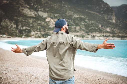 man against the backdrop of the sea and mountains