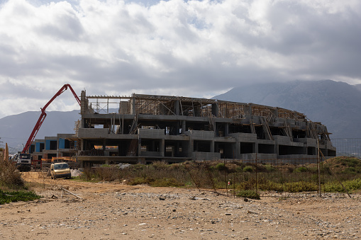 Construction site with concrete pump for a new hotel building on Crete