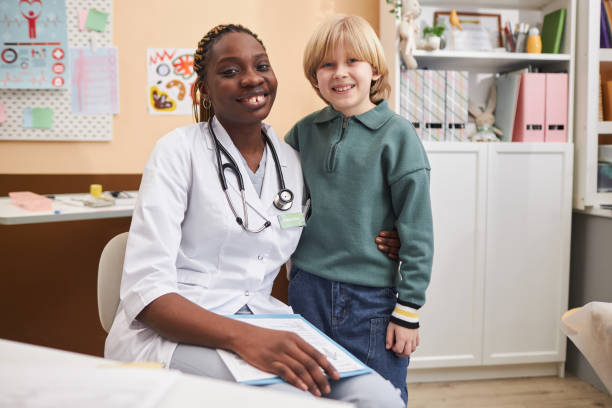 istock Doctor with little boy looking at camera 2033567933