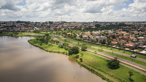 Aerial drone landscape of the São José do Rio Preto municipal dam on a sunny day, with the rivers and city on the city postcard on a cloudy day.