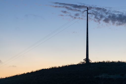 Electric pole on the hill - sunset - cirrus cloud