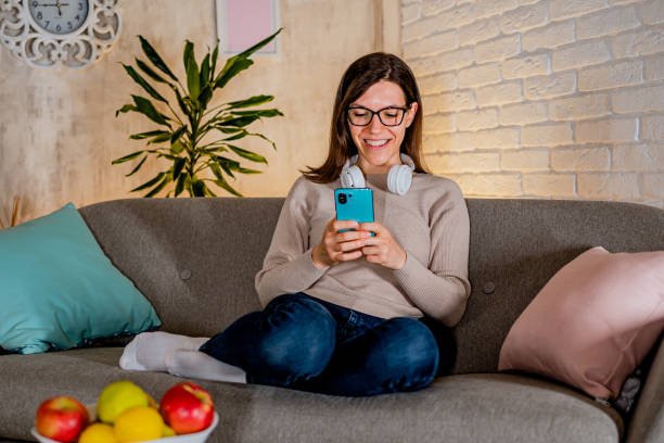 istock Woman using phone at home 2033612278