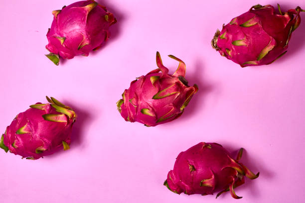 istock Red dragon fruit Set with appetizing serving on pink background. Top view 2033704887