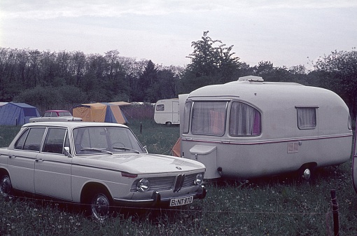 West Germany, 1967. Campsite with car and caravan trailer.