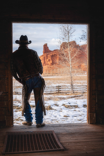 Ranch worker portrait at a Wyoming horse ranch in the winter in a rural landscape.