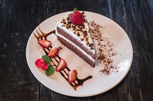 Chocolate cheesecake with fresh berries and strawberry in the plate.