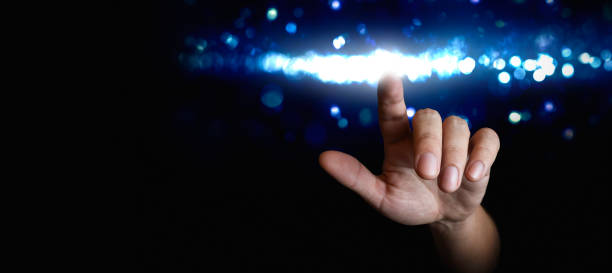 istock hand pointing finger at a light - concept of person touching cyberspace and interacting with artificial intelligence 2033868419