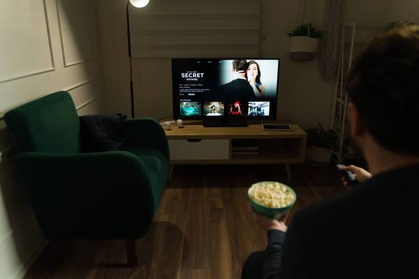 istock Relaxed man enjoying using a streaming service to watch a movie 2033911951