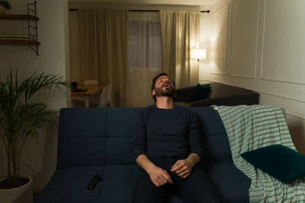 istock Tired caucasian man sleeping on the couch at home 2033928597