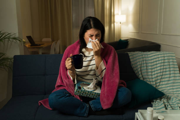 istock Young woman feeling sick with a cold at home 2033932723