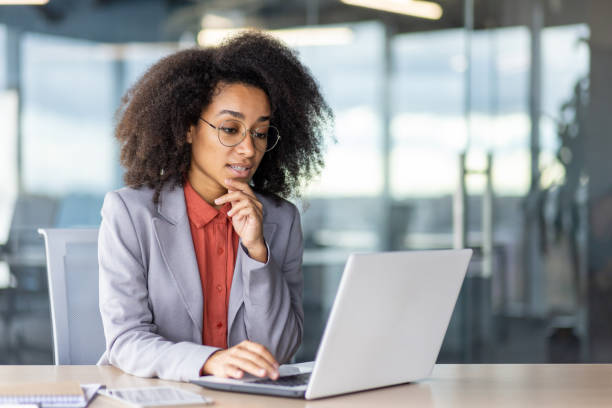 istock Woman using laptop at desk for work with office supplies 2033940064