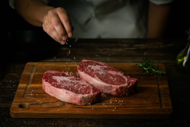 istock chef seasoning steak with salt and pepper 2033944203