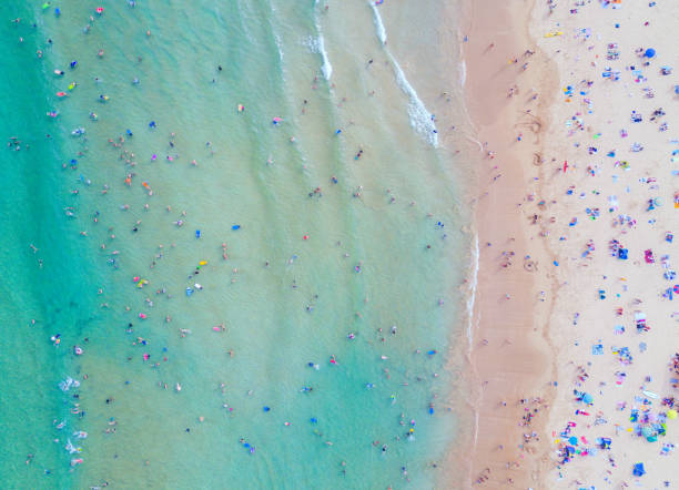 A classic Australian scene of people enjoying themselves at the beach during summertime