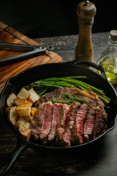 istock sliced ribeye steak in iron cast skillet pan 2034007102