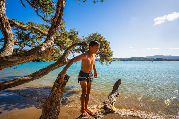 Kid enjoying a day out in nature at an island, having fun and playing, weekend activities concept.