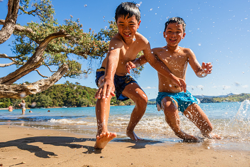 Kids out in nature playing and enjoying together at island, outdoor activities and enjoyment.