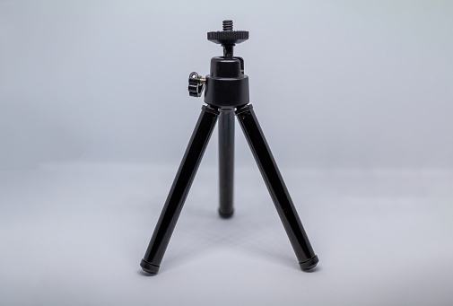 small black cell phone tripod on white background