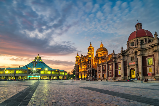 New and Old Basilica of Our Lady of Guadalupe, (Basilica de Nuestra Senora de Guadalupe) during a dramatic sunset in Mexico City, Mexico.