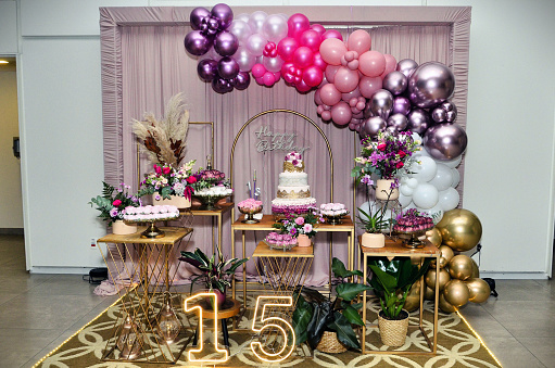 Party decorations: hats, whistles, streamers, confetti on white background. Square composition, copy space, studio shot.