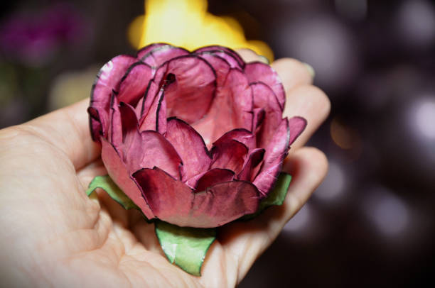 The beautiful rose-shaped fine candy mold on the palm at the party