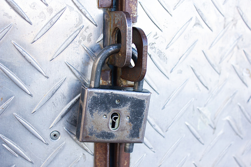 Authentic old metal padlock. Iron rusty lock close-up.