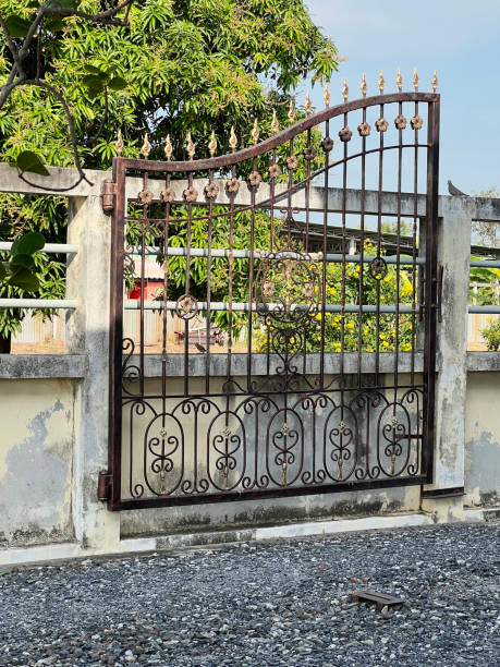 istock metal gate on a concrete fence with a metal frame. 2034098431