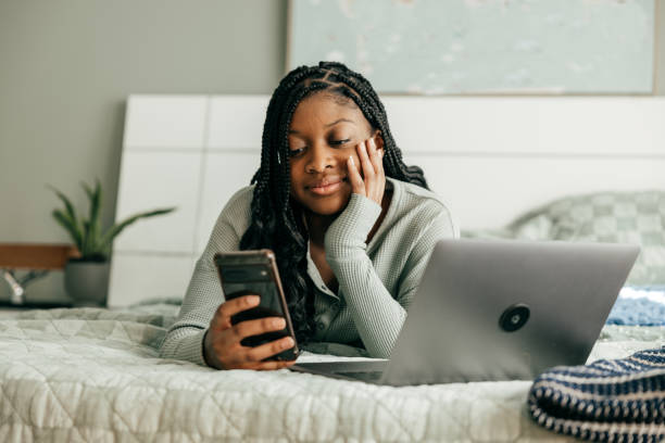 istock Smiling teen using cellphone in her room 2034159645