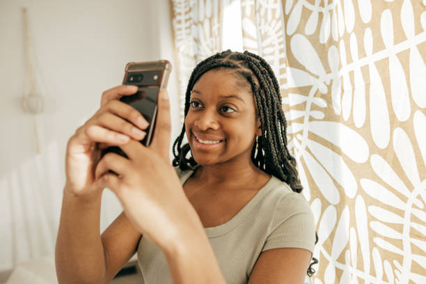 istock Teen using cellphone in her room 2034159657