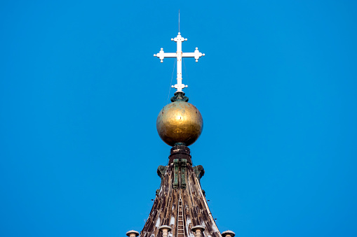 Religious cross over bell tower