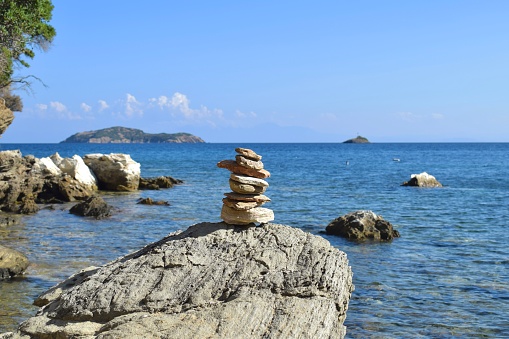 Balanced stones on a pebble beach during sunset. Croatia, Brela, Makarska. Summer and Vacation concept.