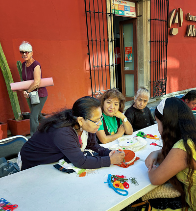 Oaxaca, Mexico: Folk artists at work at a table outside in downtown Oaxaca.