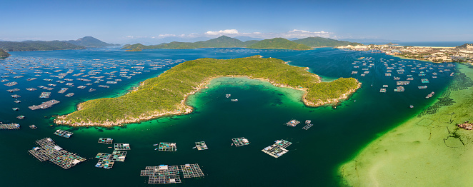 Drone view Hon Ong island in Son Dung district with hundred of fish farm, lobster cages- Khanh Hoa province, central Vietnam