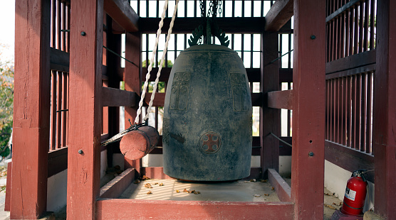 This photo shows a church bell made in traditional Korean style.  The appearance of early Korean church bells and church buildings show traces of Korea's long history and the compromise between Western and Eastern societies.  Additionally, the traditional red color gives the viewer a sense of warmth and intensity.